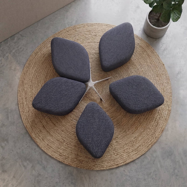 Plan view of a Blossom Seating System in grey-blue fabric, with 2 poufs stowed neatly in within the docking base and 3 poufs slightly withdrawn from the docking base.