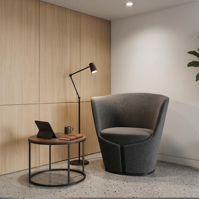 This grey Dapper Armchair makes an ideal perch in a quiet waiting area of a modern commercial workplace.