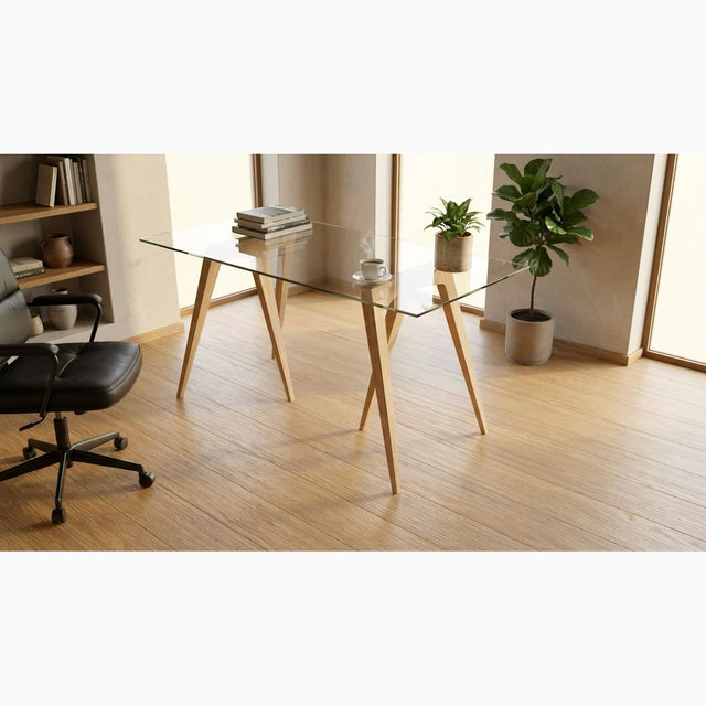 A pair of Flex Trestle Desk Legs (in Ash) with a glass tabletop takes pride of place in a modern, uncluttered home office.