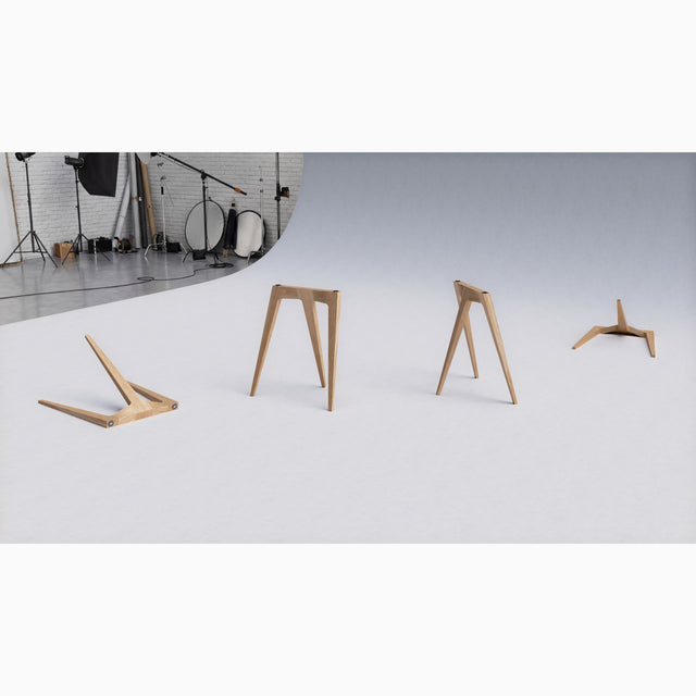 Four Flex Desk Legs scattered on a studio backdrop to show its form and construction from different angles.