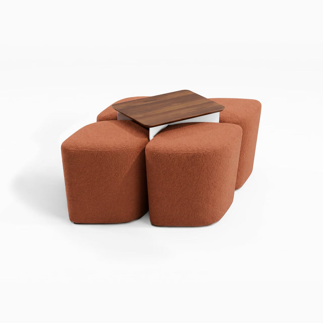 Four diamond-shaped poufs in a terracotta fabric arranged around a table, creating a rhombus-shaped formation.