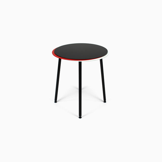 The steel Stacked side table comprises 3 tabletops in a pile. This version has a black top, red middle & white bottom.