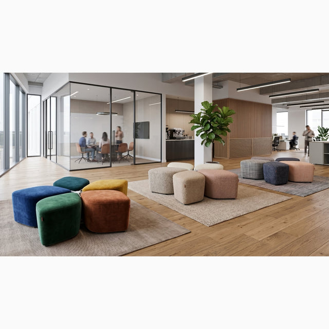 Three Blossom Seating Systems upholstered in a range of fabrics, and neatly arranged, in a shared space of a modern office.