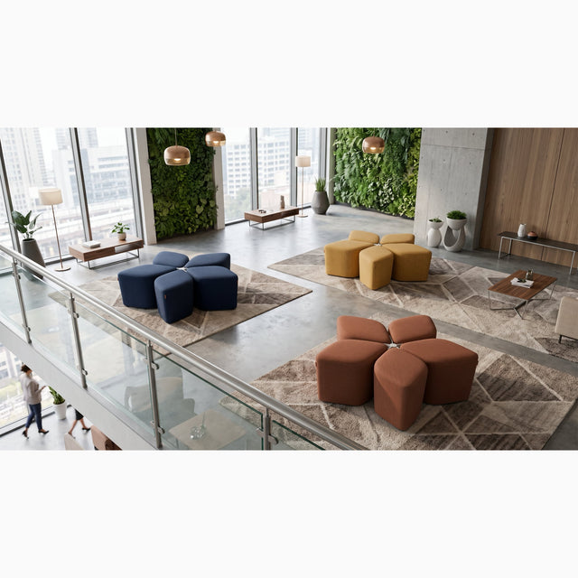 Three Blossom Seating Systems each in a different coloured fabric, neatly arranged in an open plan communal space.