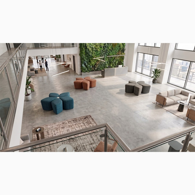 Three Blossom Seating Systems in different colours adorn a large open plan shared space in a modern office.
