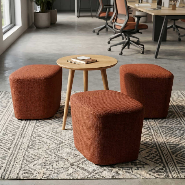 Three Petal poufs in premium orange-red textile surrounds a wooden side table.