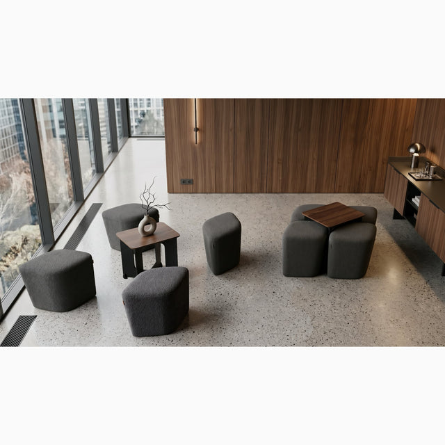 A luxury waiting space in a boutique hotel features two Rhombic seating systems, each with grey poufs and walnut tables.