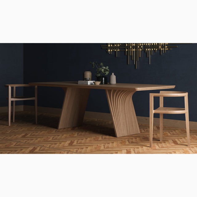 The Veer dining table in solid Oak. Its two monobloc bases are constructed from layers of curved wood.