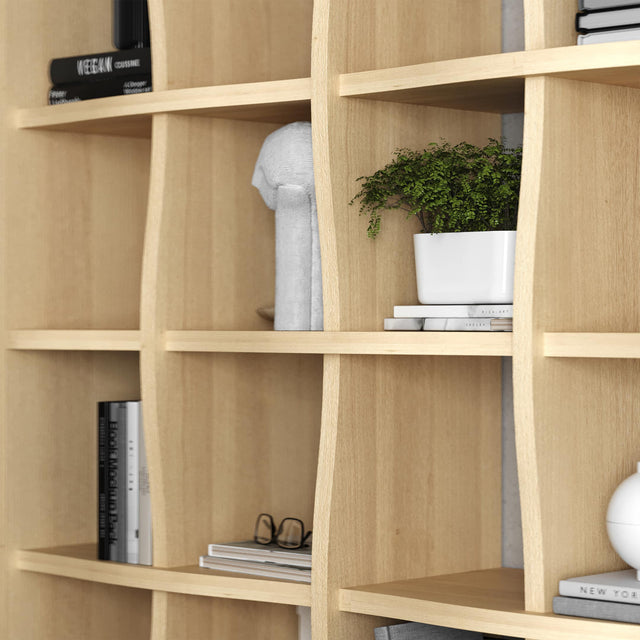 Closeup of the Weave bookcase in whitened Oak. The shelves and supports appear to interknit, much like many woven structures.