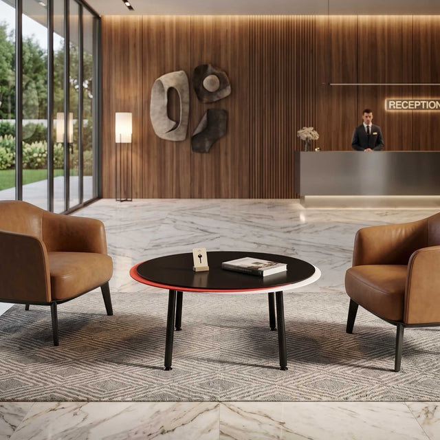 A black, red and white Stacked coffee table stands between 2 leather armchairs in an upmarket, wooden-clad reception of a boutique hotel.