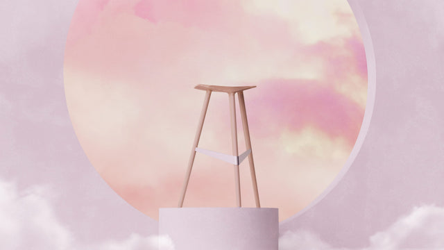 A single Delta bar stool stands tall on a podium, showcasing its streamlined form-factor and dynamic stance.