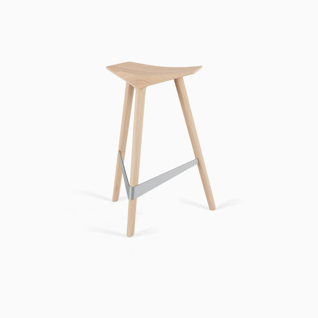 A Delta counter stool in solid Ash, with a brushed stainless steel footrest.