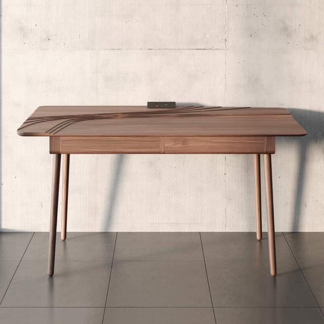 The Terrace desk in solid Walnut offers a comfortable and practical work solution despite its sculptural qualities.