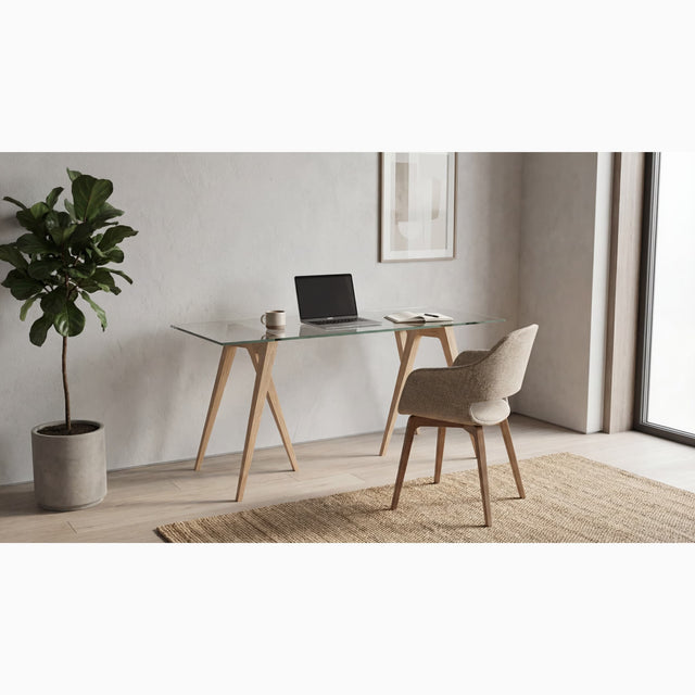 A pair of Flex Desk Trestle Legs, in Ash, with a clear glass tabletop in a contemporary home office.