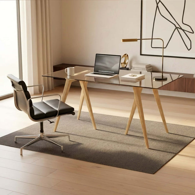 The Flex Trestle Desk Legs in Ash, paired with a glass tabletop, in a smart, modern home office.