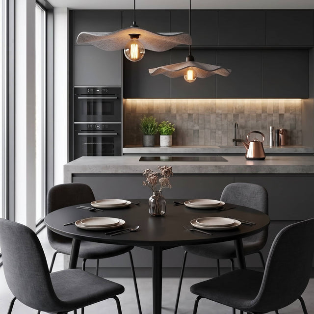One large and one medium Flutter acoustic pendant light hang over a dining table in a modern kitchen diner.