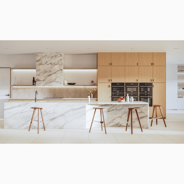 Four Walnut Delta stools take pride of place in a contemporary kitchen. The stool’s sleek design complements the clean, minimalist lines of the kitchen’s aesthetics.