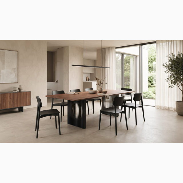 The Phantom dining room with a Walnut tabletop and black slatted base features in this modern living space with stonewashed walls and smart, contemporary furniture.