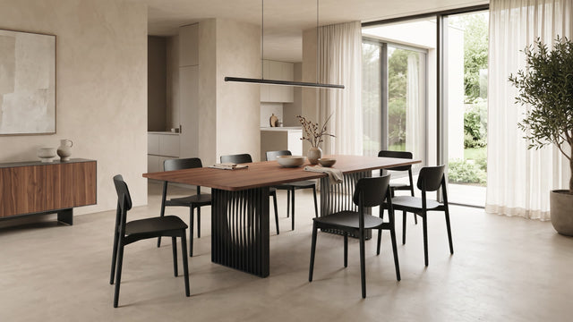 The Phantom dining room with a Walnut tabletop and black slatted base features in this modern living space with stonewashed walls and smart, contemporary furniture.