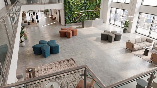 Three Blossom Seating Systems in different colours adorn a large open plan shared space in a modern office.