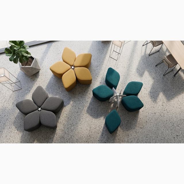 Plan view of 3 Blossom Seating Systems in an office, with two systems neatly arranged into the flower motif and the third system with its five poufs haphazardly placed around its docking base.