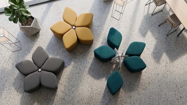 Plan view of 3 Blossom Seating Systems in an office, with two systems neatly arranged into the flower motif and the third system with its five poufs haphazardly placed around its docking base.
