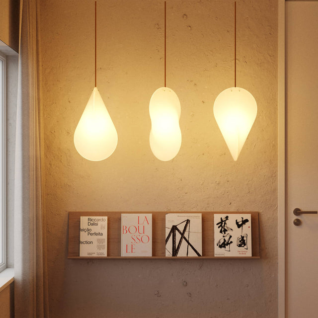 Three illuminated Oh Lloyd pendant lights demonstrating how it’s form appears different at different viewing angles.