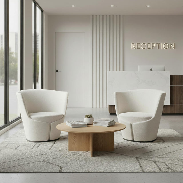 Two Dapper Armchairs in an off-white mini boucle fabric located in an office reception area.