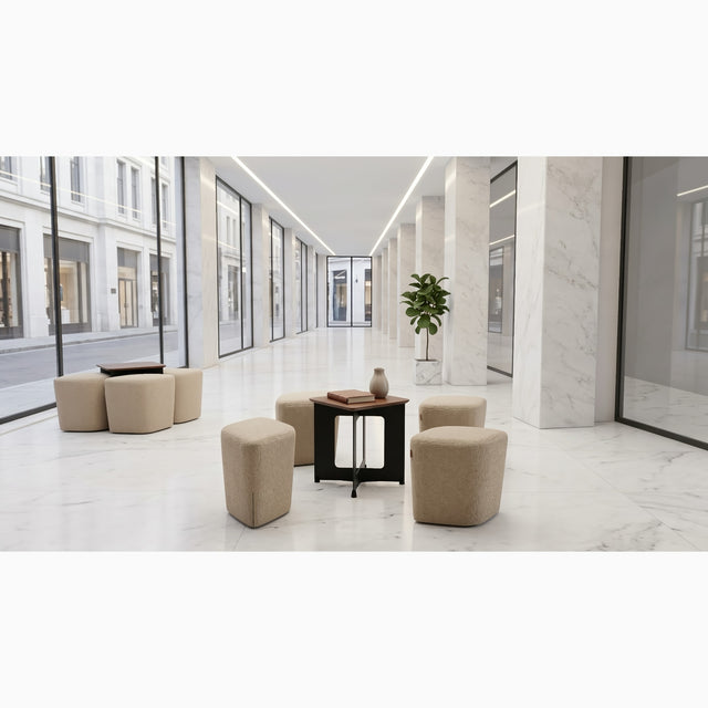 A marble lined lobby houses two Rhombic seating systems with tables. The poufs are upholstered in a pale brown fabric, and the tables have black frames with walnut tabletops.