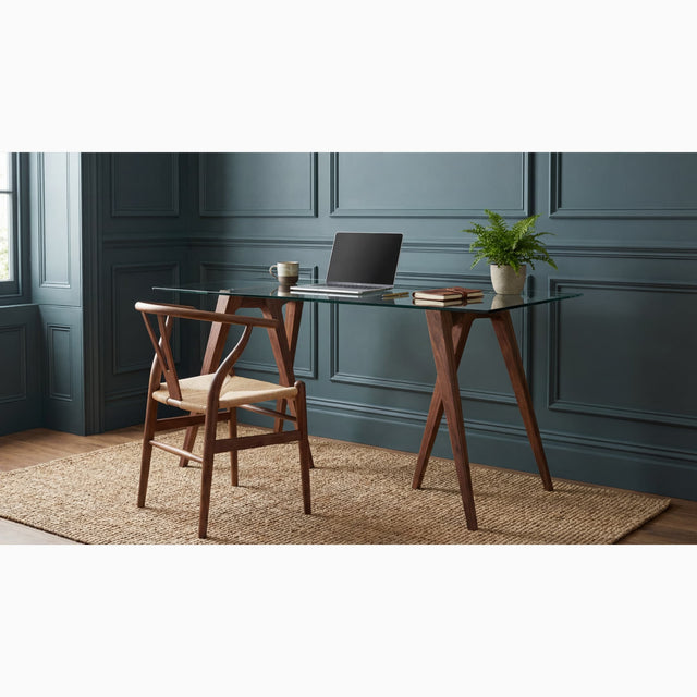 Two Walnut Flex Desk Trestles Legs with a glass tabletop in a home office with heritage green paint and bead wall panelling.