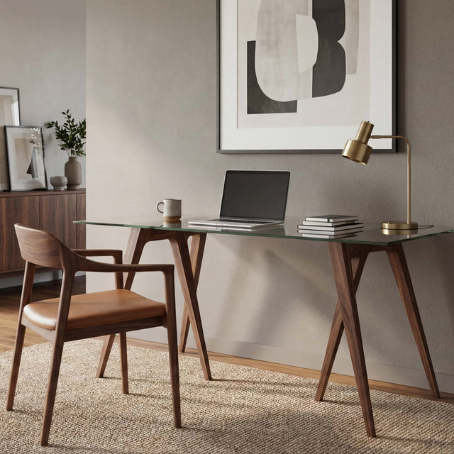 A pair of Flex Desk Trestle Legs (made of Walnut) with a glass tabletop makes for a smart, minimal desk in a contemporary home office.